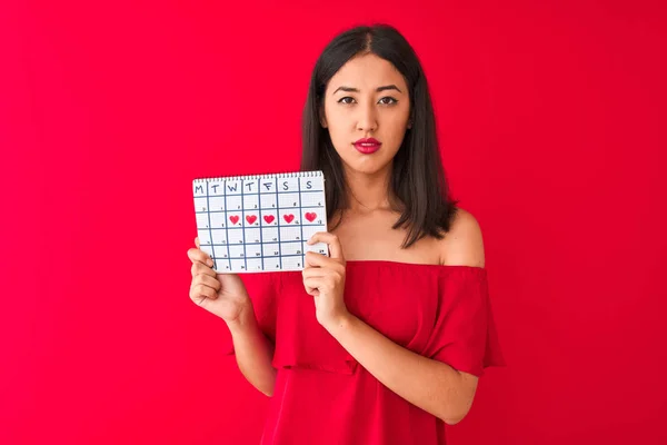 Young Beautiful Chinese Woman Holding Period Calendar Standing Isolated Red — Stock Photo, Image