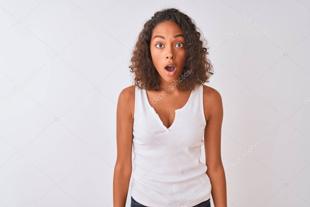 Young brazilian woman wearing casual t-shirt standing over isolated white background afraid and shocked with surprise and amazed expression, fear and excited face.
