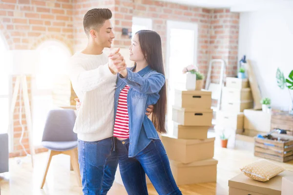 Unga asiatiska par dans och leende firar flyttar till en n — Stockfoto