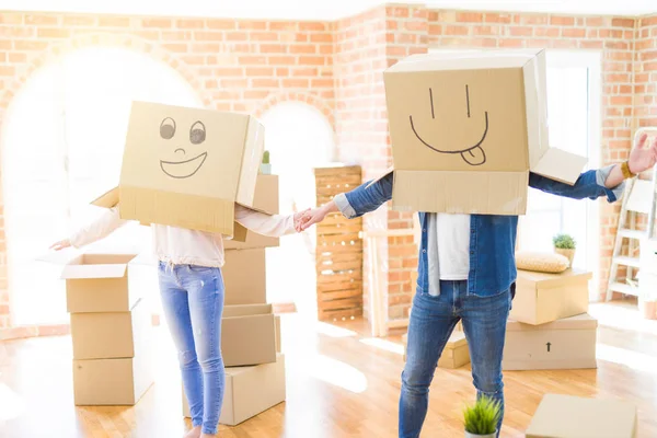 Par ha kul på ny lägenhet klädd i lådor med roligt ansikte — Stockfoto