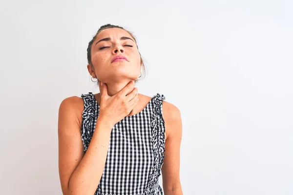 Beautiful woman with bun wearing casual dresss standing over isolated white background Touching painful neck, sore throat for flu, clod and infection