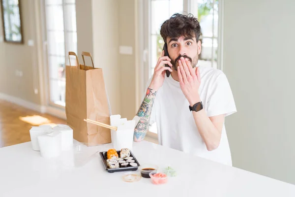 Joven Comiendo Sushi Asiático Entrega Domicilio Pidiendo Comida Hablando Smartphone — Foto de Stock