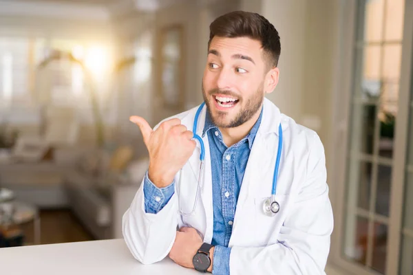 Young Handsome Doctor Man Clinic Smiling Happy Face Looking Pointing — Stock Photo, Image