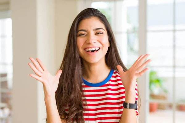 Beautiful young woman celebrating excited for success, screaming