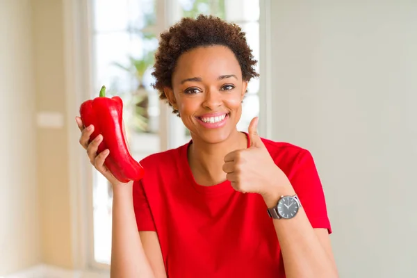 若いアフリカ系アメリカ人女性は Okサインをやって大きな笑顔で幸せな新鮮な赤コショウを保持し 指で親指 優れた兆候 — ストック写真