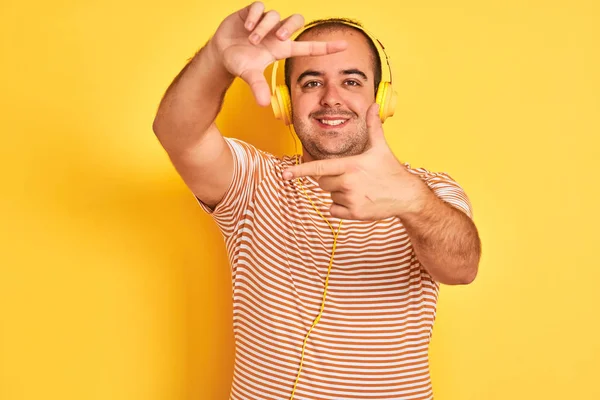 Mladý Muž Poslouchá Hudbu Používající Sluchátka Stojící Nad Izolovaným Žlutým — Stock fotografie