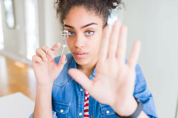 Jovem Afro Americana Usando Cílios Curler Com Mão Aberta Fazendo — Fotografia de Stock