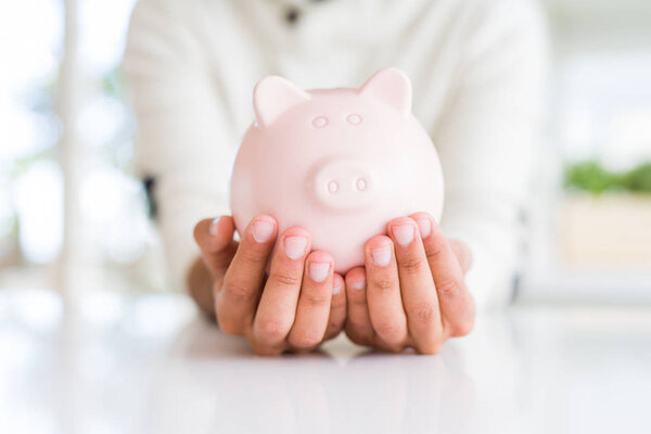 Man holding safe piggy bank, insurance concept
