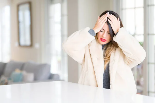 Young Beautiful Woman Wearing Winter Fur Coat Home Suffering Headache — Stock Photo, Image