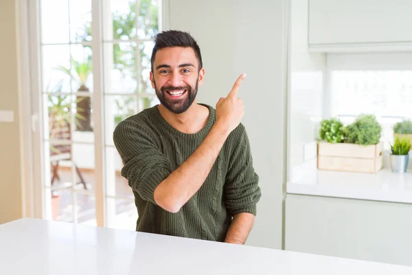 Handsome man pointing with arms and fingers, smiling cheerful wi — Stock Photo, Image