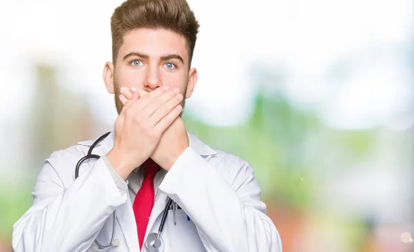Young Handsome Doctor Man Wearing Medical Coat Shocked Covering Mouth — Stock Photo, Image