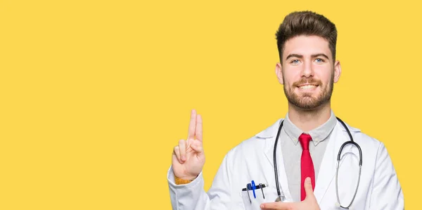 Young handsome doctor man wearing medical coat Swearing with hand on chest and fingers, making a loyalty promise oath