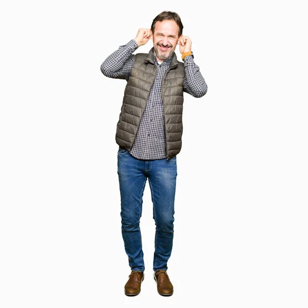 Middle Age Handsome Man Wearing Winter Vest Smiling Pulling Ears — Stock Photo, Image