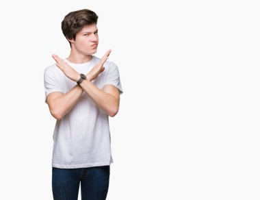 Young handsome man wearing casual white t-shirt over isolated background Rejection expression crossing arms doing negative sign, angry face clipart