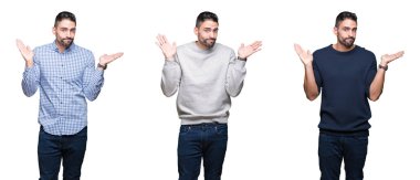 Kolaj yakışıklı iş adamı üzerinde beyaz bir arka plan clueless ve şaşkın bir ifadeyle kollar ve eller kaldırdı izole. Şüphe kavramı.