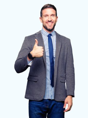 El ile jest kadar mutlu thumbs yapıyor takım elbise ve kravat giyen yakışıklı iş adam. Başarı göstererek kameraya bakarak ifadeyi onaylama.