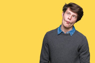 Genç yakışıklı zarif adam izole arka plan yapma balık yüzüne dudaklı, çılgın ve komik bir jest. Komik ifade.