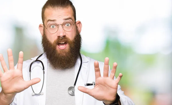 Young Blond Doctor Man Beard Wearing Medical Coat Afraid Terrified — Stock Photo, Image