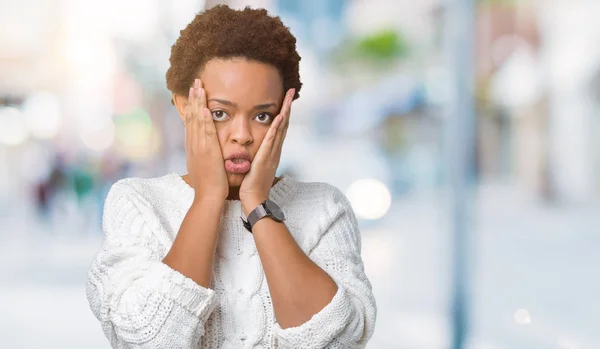 Beautiful young african american woman wearing sweater over isolated background Tired hands covering face, depression and sadness, upset and irritated for problem