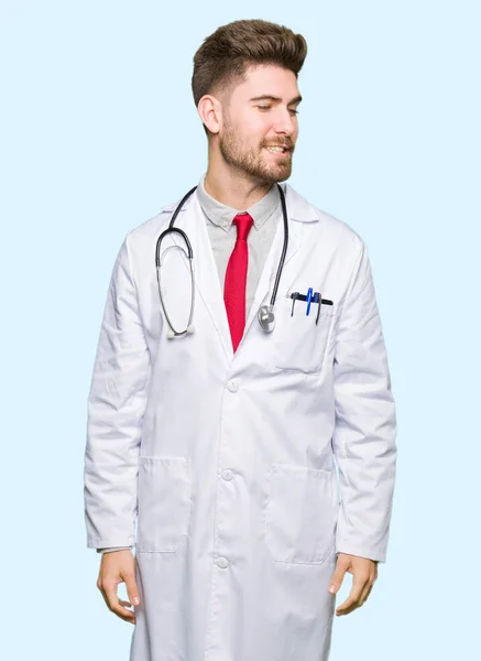 Young Handsome Doctor Man Wearing Medical Coat Looking Away Side — Stock Photo, Image