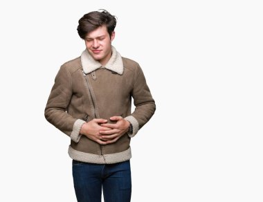 Genç yakışıklı adam giyen kış ceket mide üzerinde el ile izole arka plan üzerinde çünkü hazımsızlık, ağrılı hastalık hasta hissediyor. Ağrısı kavramı.