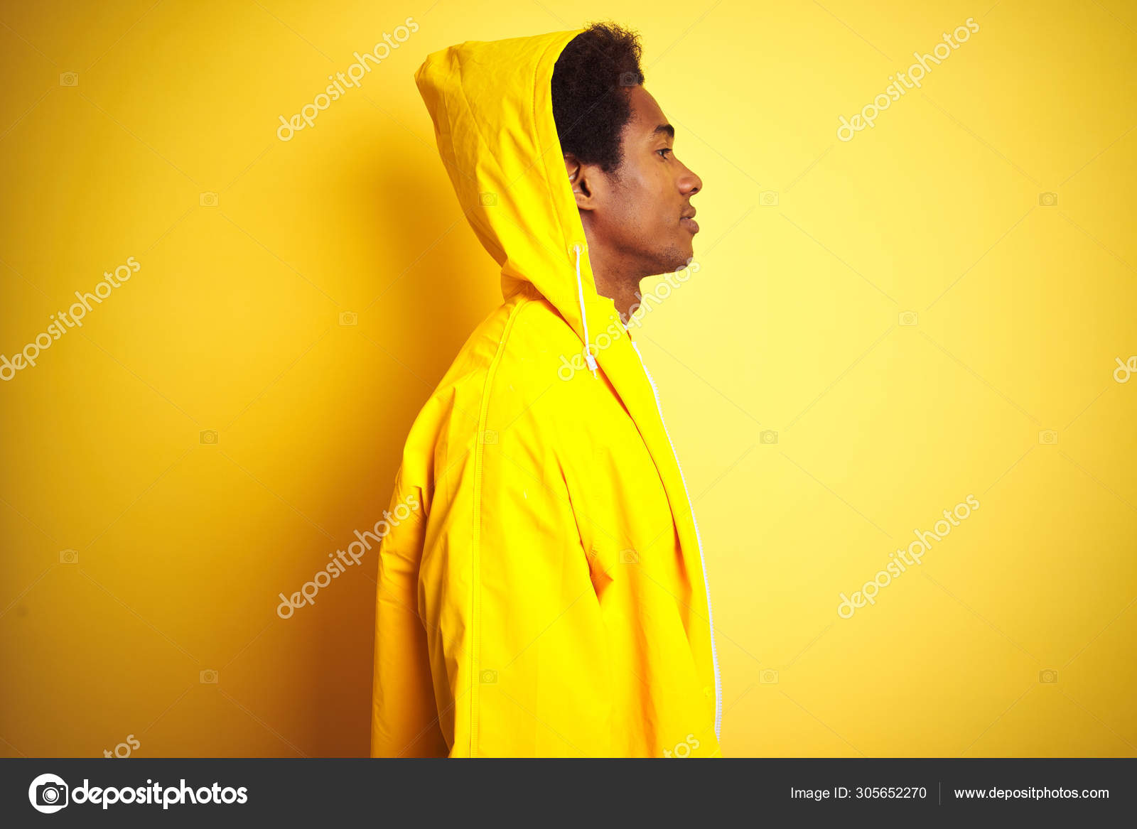 African Man Afro Hair Wearing Rain Coat Hood Standing Isolated