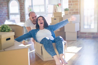 Komik ve çılgın çift bir araba olarak bir cardboad kutusu sürme eğlenceli sahip, mutlu gülümseyen ve yeni evde gülüyorsun