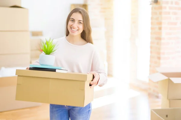 Mooie jonge vrouw glimlachend gelukkig verhuizen naar een nieuw huis, zeer e — Stockfoto