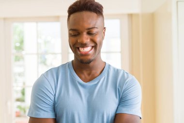 Çapraz kolları ile neşeli gülümseyen Afrika yakışıklı genç