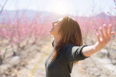 Pembe Şeftali çiçek ortasında güzel orta yaş kadın