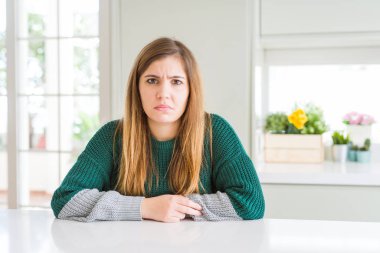 Young beautiful plus size woman wearing casual striped sweater depressed and worry for distress, crying angry and afraid. Sad expression.