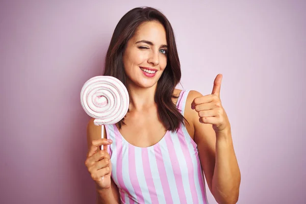 Young Beautiful Woman Eating Sweet Candy Pink Isolated Background Happy — Stock Photo, Image