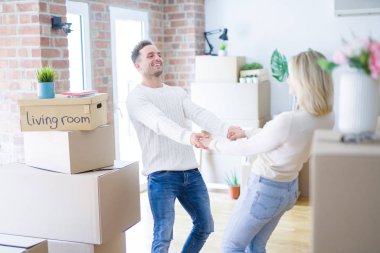 Karton kutular etrafında yeni evde dans genç güzel çift