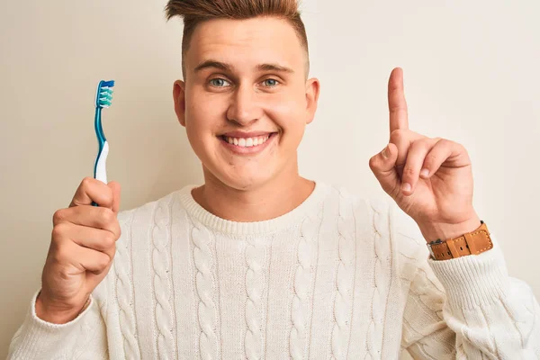 Jonge Knappe Man Houdt Tandenborstel Staande Geïsoleerde Witte Achtergrond Verrast — Stockfoto