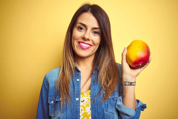 Young Beautiful Woman Eating Fresh Healthy Mango Yellow Background Happy — Stock Photo, Image