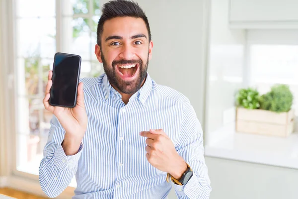 Handsome Hispanic Business Man Showing Smartphone Screen Surprise Face Pointing — Stock Photo, Image