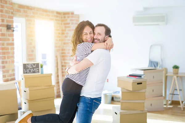 Middle age senior couple moving to a new house, smiling happy in love with apartmant