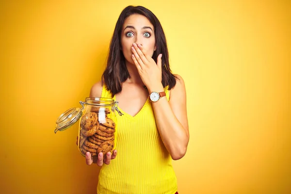 Jovem Bela Mulher Segurando Frasco Biscoitos Sobre Amarelo Isolado Fundo — Fotografia de Stock