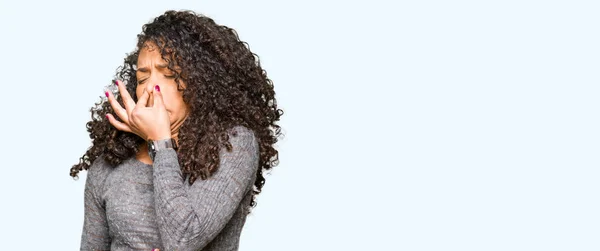 Young Beautiful Woman Curly Hair Wearing Grey Sweater Smelling Something — Stock Photo, Image