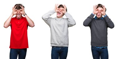 Kolaj dilini dışarı, parmaklarının arasından baktığını dürbün gibi ok jest yapıyor beyaz izole arka plan üzerinde genç adam. Deli ifade.