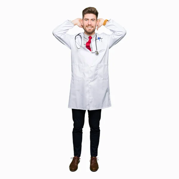 Young Handsome Doctor Man Wearing Medical Coat Relaxing Stretching Arms — Stock Photo, Image