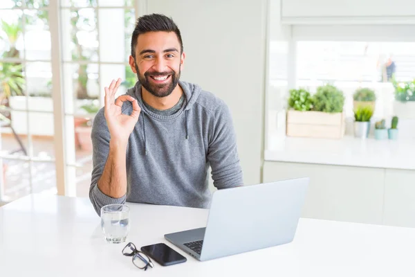 Hombre Hispano Guapo Trabajando Con Computadora Portátil Haciendo Signo Con — Foto de Stock