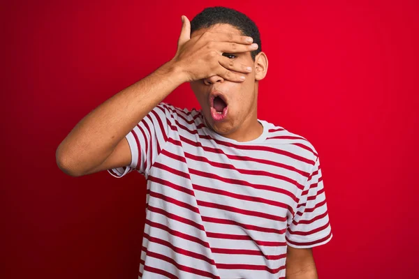 Jonge Knappe Arabische Man Draagt Gestreept Shirt Geïsoleerde Rode Achtergrond — Stockfoto