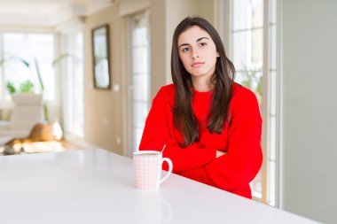 Bir fincan sade kahve şüpheci ve sinir, onaylamayan ifade yüz çapraz kolları olan içme güzel ve genç birbayan. Negatif kişi.