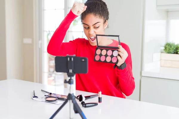 Young african american influencer woman recording make up tutorial annoyed and frustrated shouting with anger, crazy and yelling with raised hand, anger concept