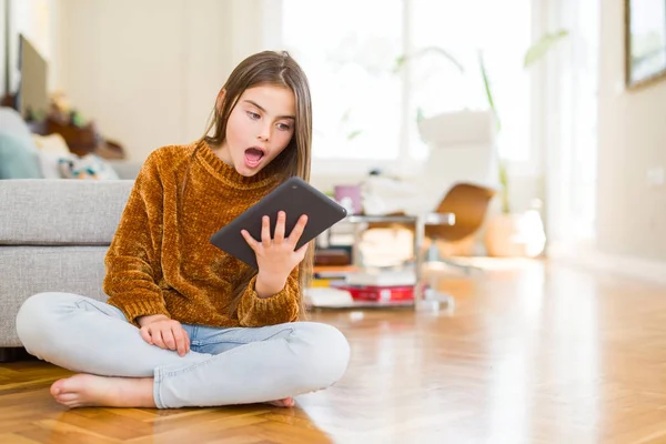 Hermosa Niña Usando Tableta Digital Táctil Sentada Suelo Asustada Shock — Foto de Stock