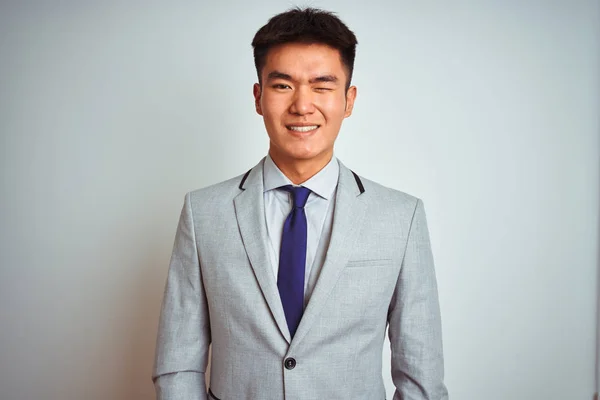 Asian chinese businessman wearing suit and tie standing over isolated yellow background winking looking at the camera with sexy expression, cheerful and happy face. — Stock Image Asian Chinese Businessman Wearing Suit Tie Standing Isolated Yellow Background Royalty Free Stock Images