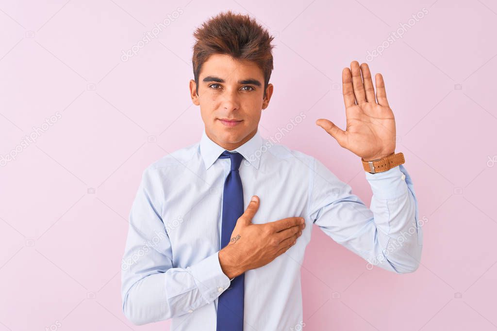 Young handsome businessman wearing shirt and tie standing over isolated pink background Swearing with hand on chest and open palm, making a loyalty promise oath
