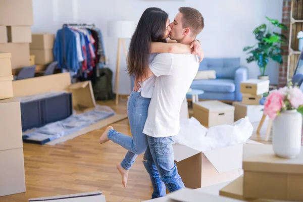 Young Beautiful Couple Hugging New Home Cardboard Boxes — Stock Photo, Image