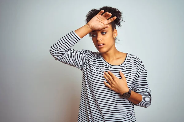 African american woman wearing navy striped t-shirt standing over isolated white background Touching forehead for illness and fever, flu and cold, virus sick